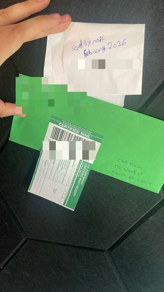 Certified mail envelope and green receipt
